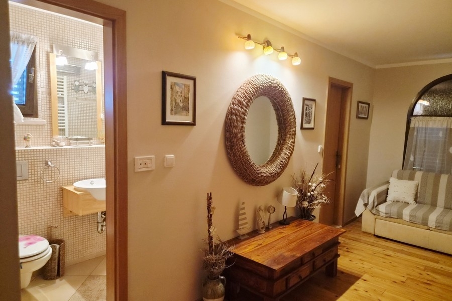 Living room with mirror and view of the bathroom