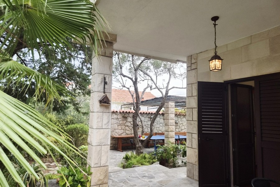 Entrance with lantern and palm trees