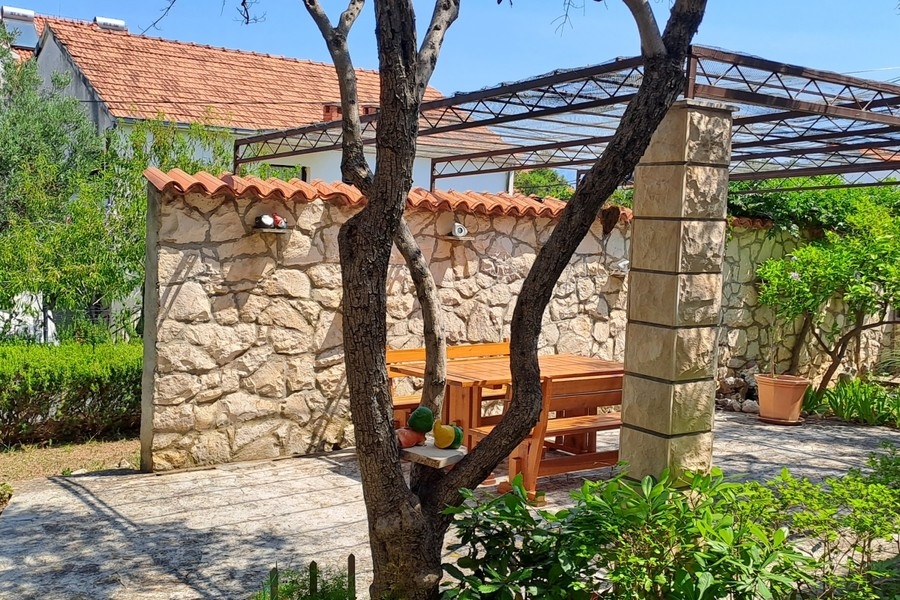 Courtyard with stone wall and garden furniture