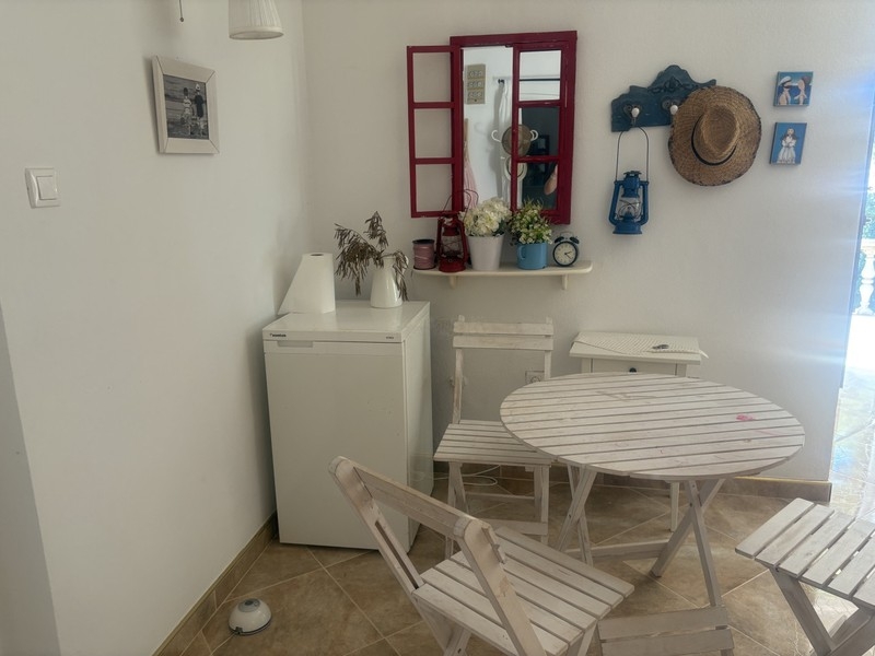 Sitting area with white table and chairs