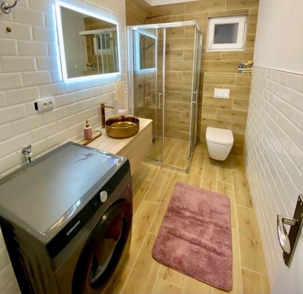 Bathroom with shower and washing machine