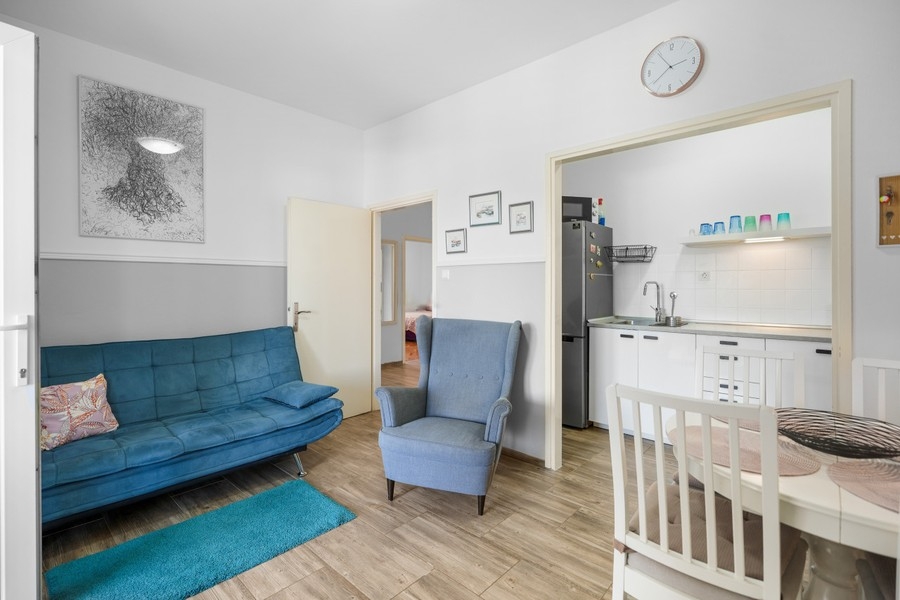 Living room with sofa and view of the kitchen