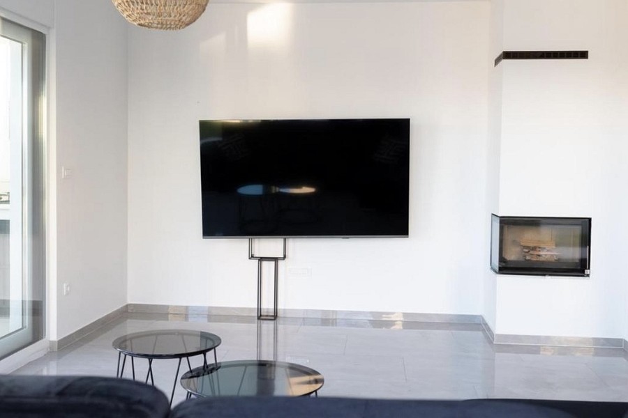 Living room with fireplace and large television