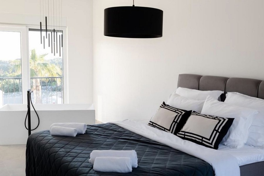 Bedroom with freestanding bathtub