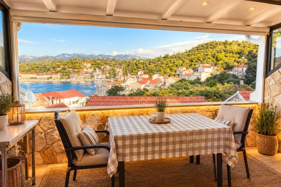 Covered terrace with dining table and sea views