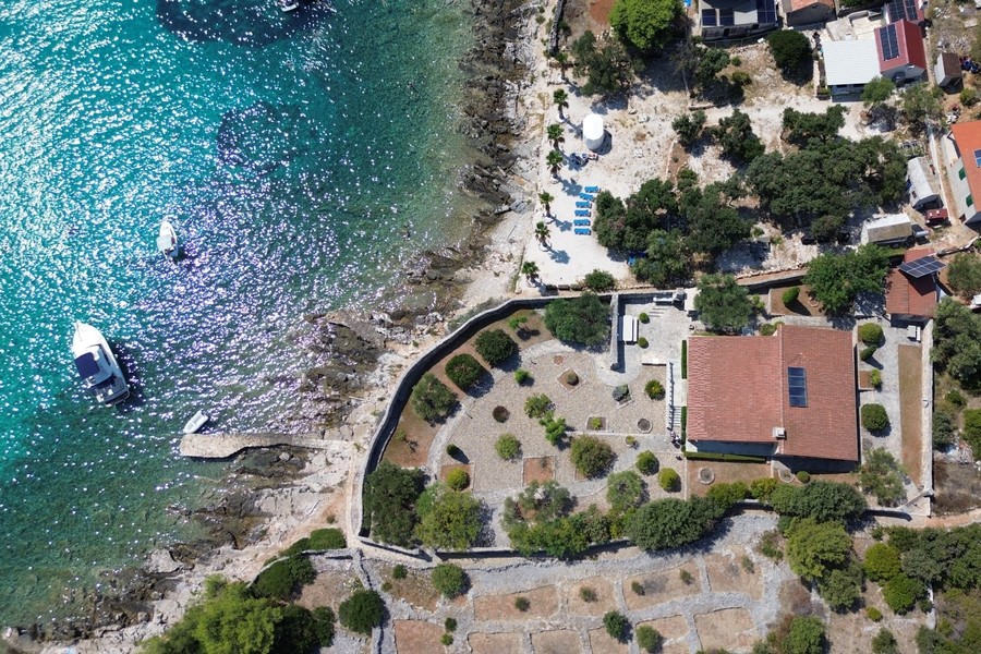Aerial view of the bay with stone villa on the water