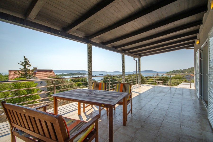 Terrace of the second villa with seating area and sea view