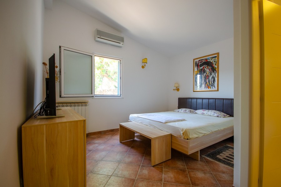 Bedroom with double bed and television