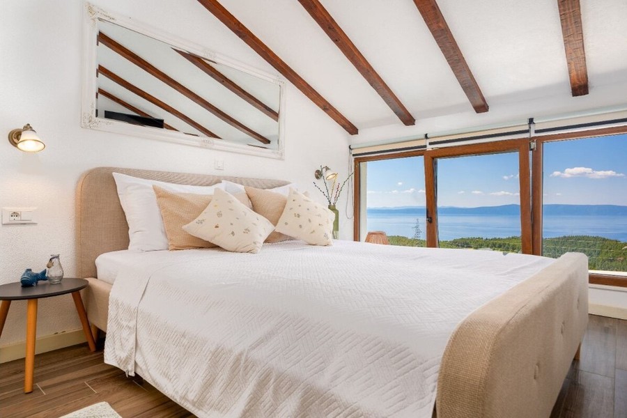 Bedroom with exposed beams and sea views