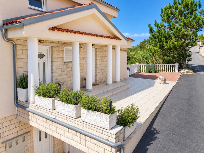 Entrance with columns, flower boxes and terrace