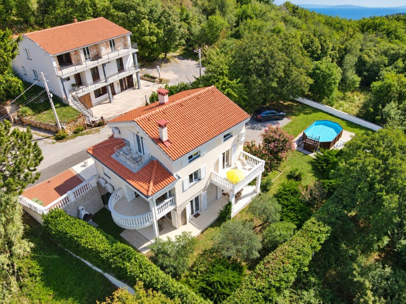 House with pool, garden and balconies from above