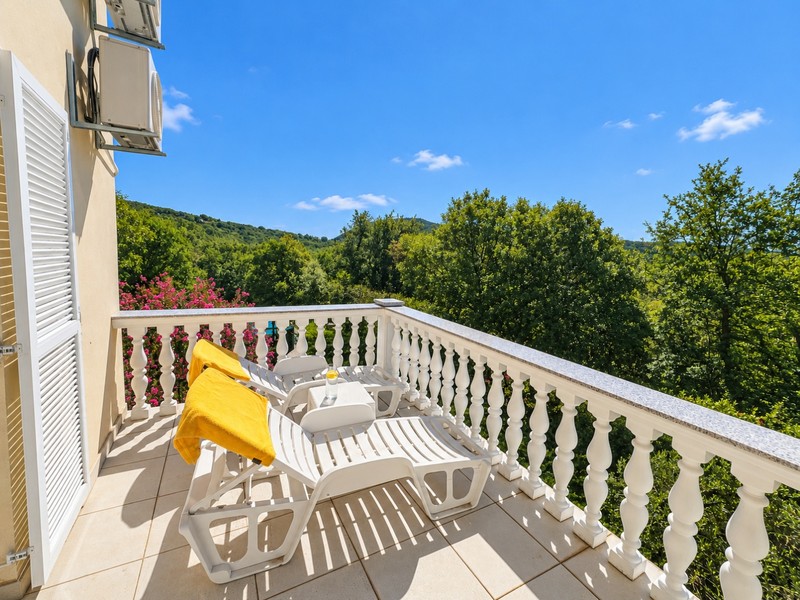 Balcony with loungers and a view of the greenery