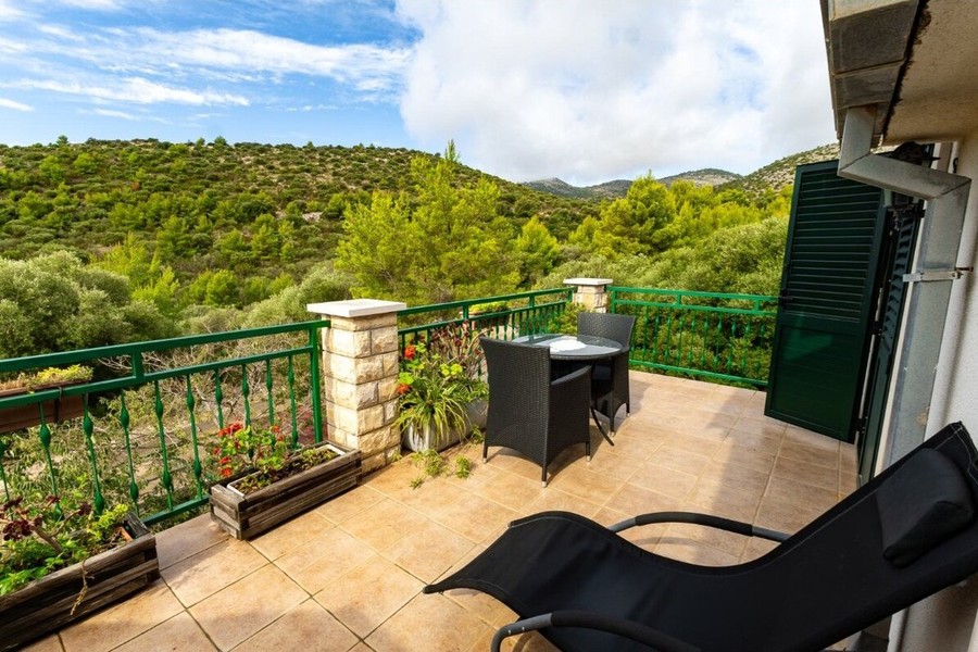 Terrace with seating group and sun lounger