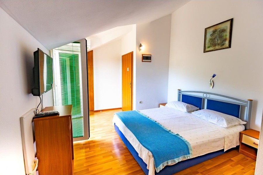 Bedroom with double bed and television
