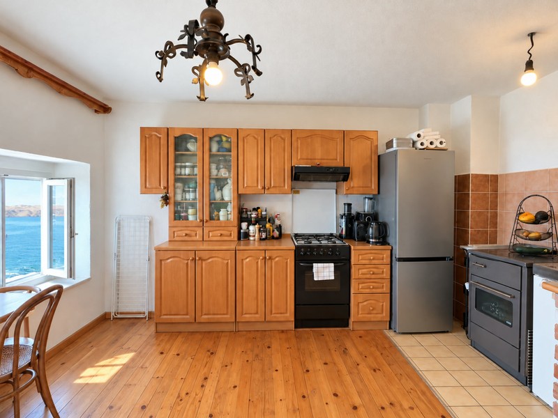 Kitchen with refrigerator and gas hob
