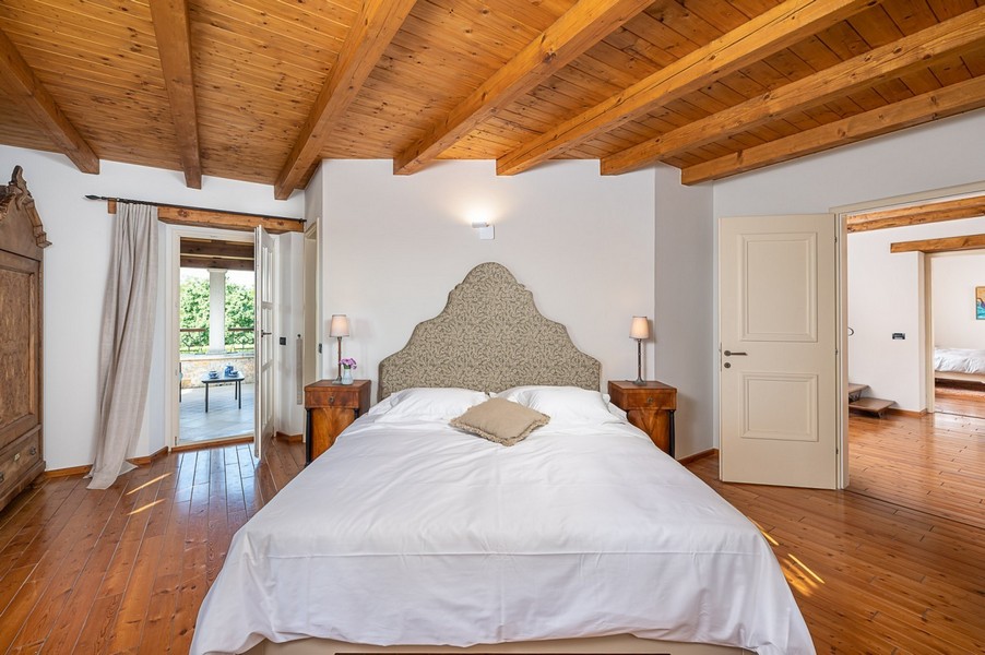 Bedroom with upholstered headboard and wooden floor