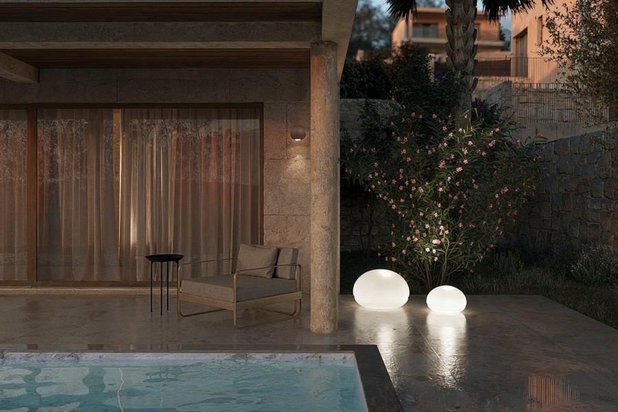 Illuminated pool and seating area in the evening