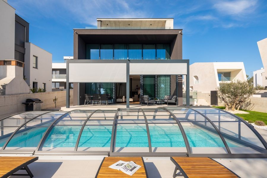 Villa with pool canopy and sun loungers
