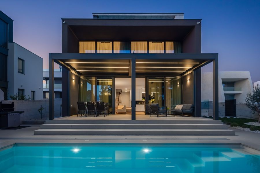 Villa in the evening with illuminated pool