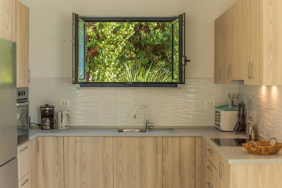 Kitchen with wooden cabinet fronts and window