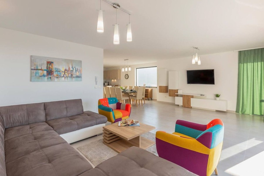 Living room with corner sofa and coloured armchairs
