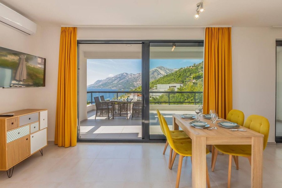 Dining area with yellow chairs and sea view