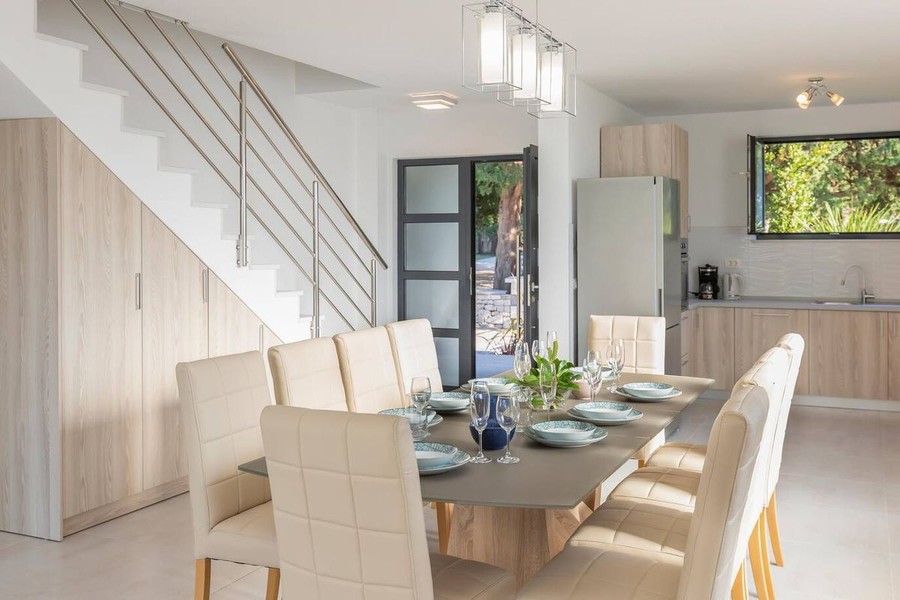 Dining area with large table and staircase