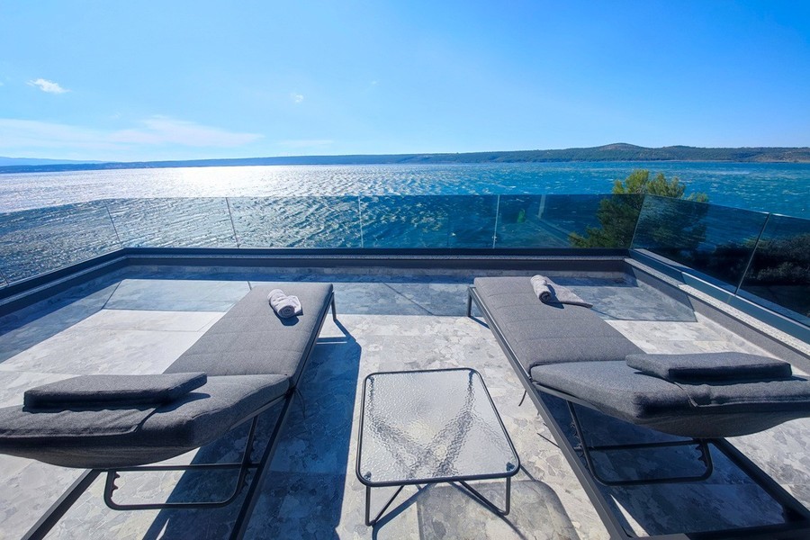 Terrace with sun loungers overlooking the sea