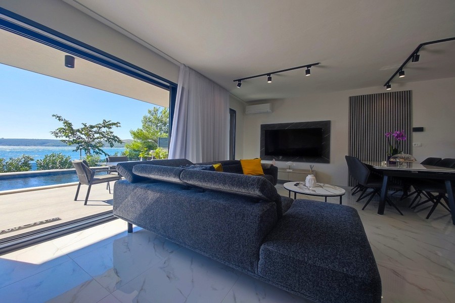 Living room with corner sofa and view of the sea