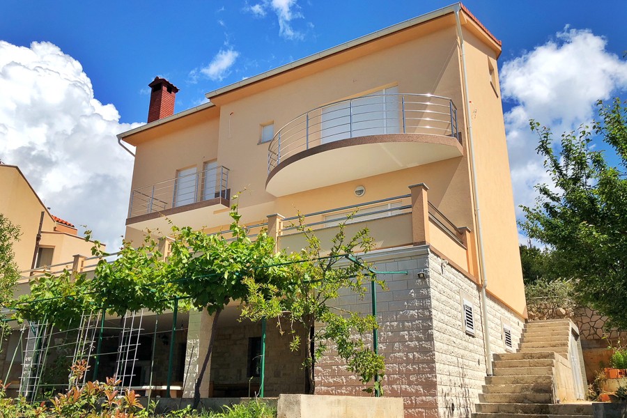 House with round balcony and external staircase