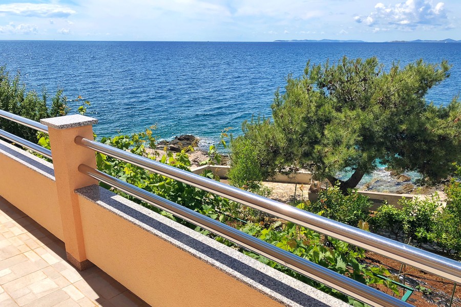 Balcony with view of pine trees and sea