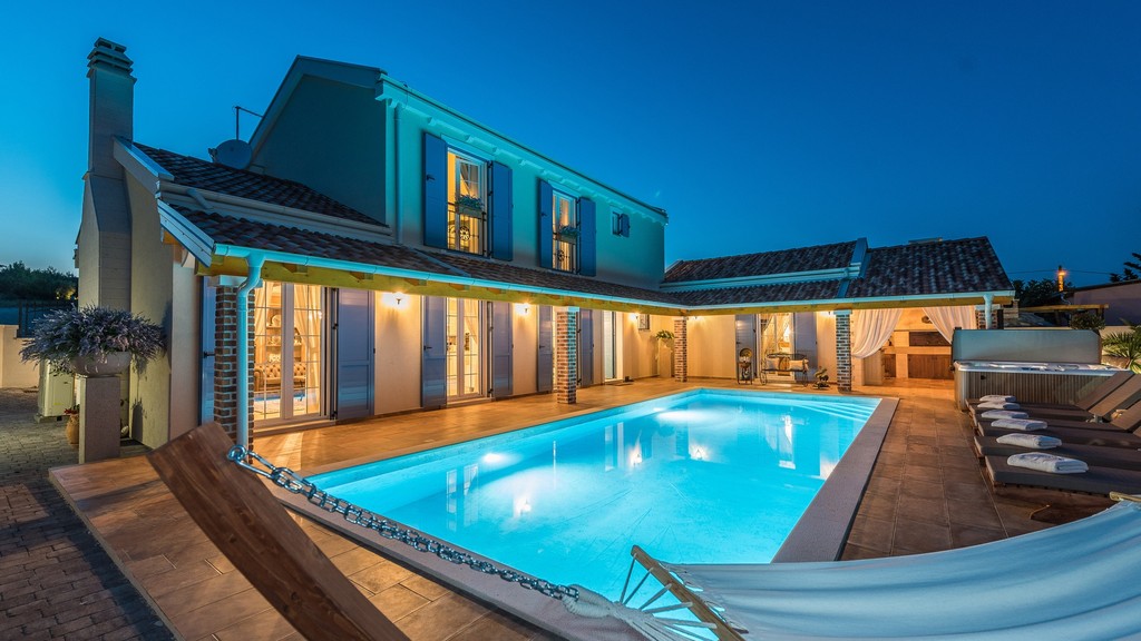Villa in the evening with pool and hammock