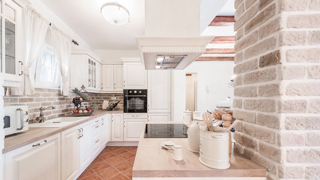 Kitchen with white country-style cabinets