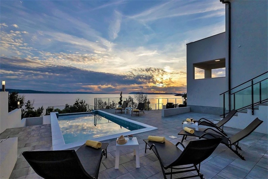 Pool and sun loungers at sunset