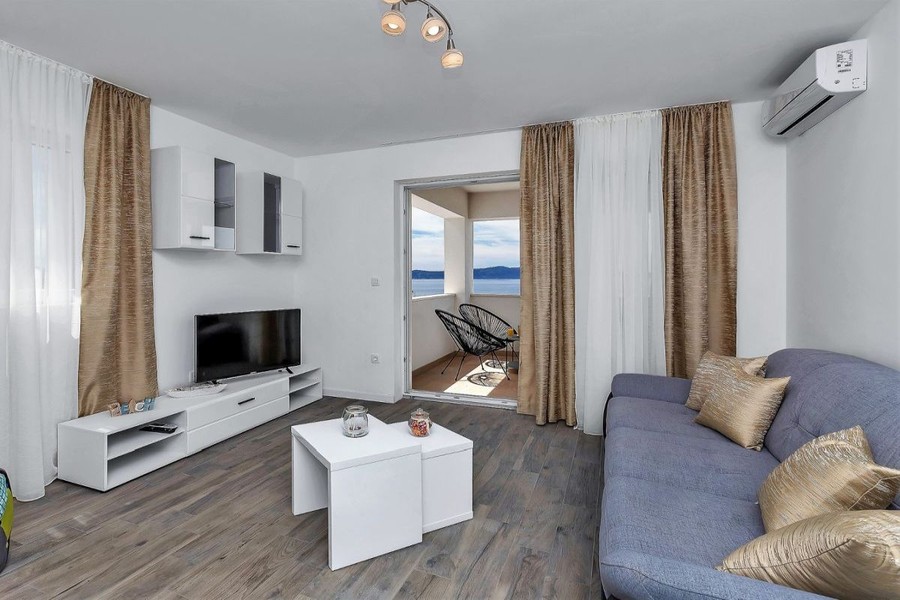 Living room with sofa and view towards the terrace