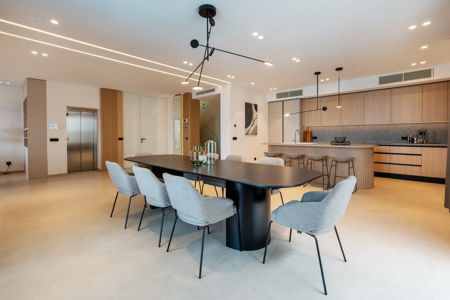 Dining table in front of the open-plan kitchen