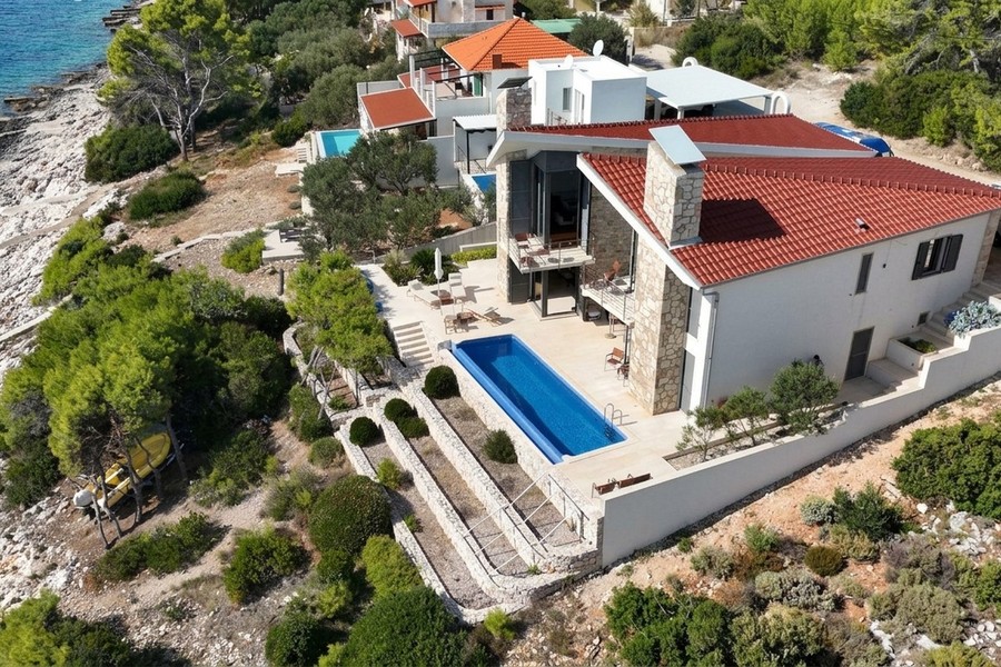 Villa with pool on a slope above the sea