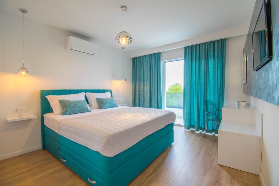 Bedroom with turquoise curtains