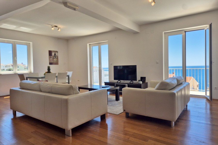 Living room with leather sofas and sea view
