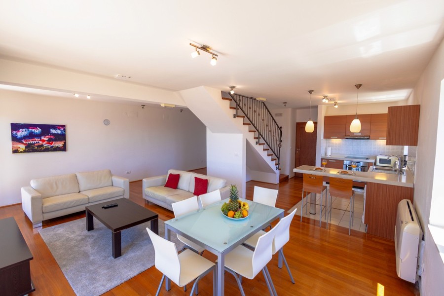 Living area with dining table and staircase