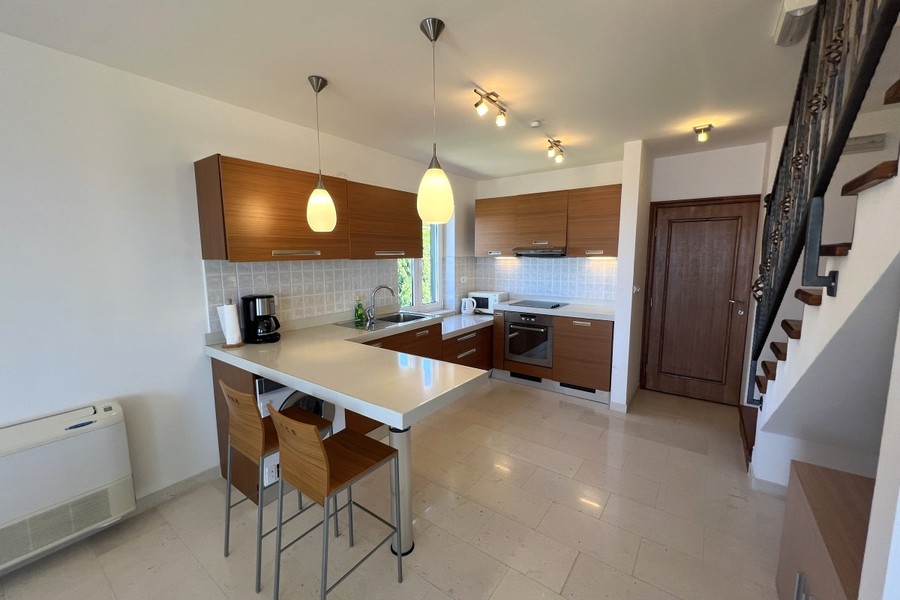 Kitchen with breakfast bar and staircase