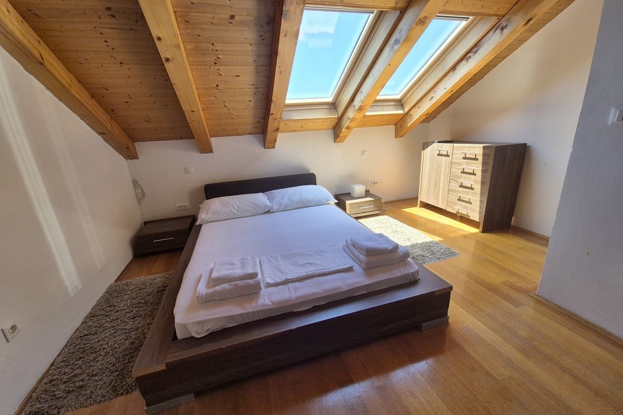 Bedroom with roof windows and chest of drawers