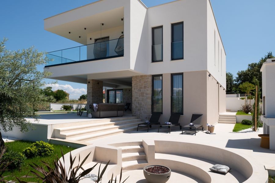 Modern villa with pool and seating area in the garden