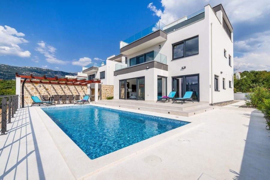 White villa with pool and sun loungers