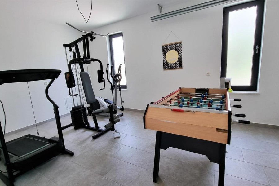 Room with fitness equipment and table football