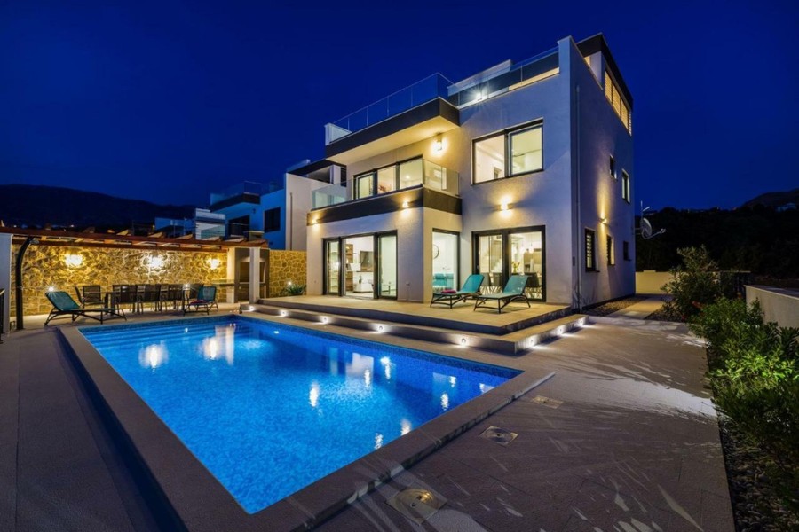 Villa in the evening with illuminated pool