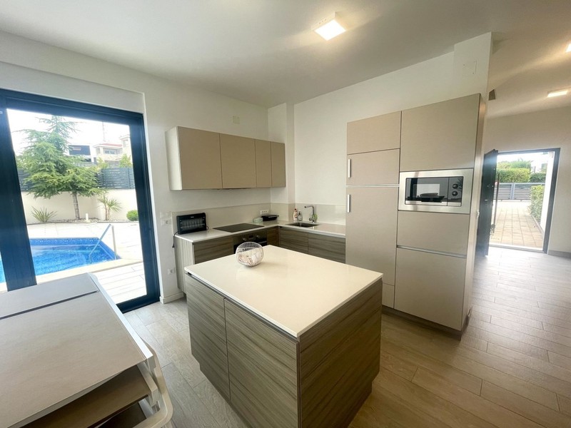 Kitchen with island unit and pool view
