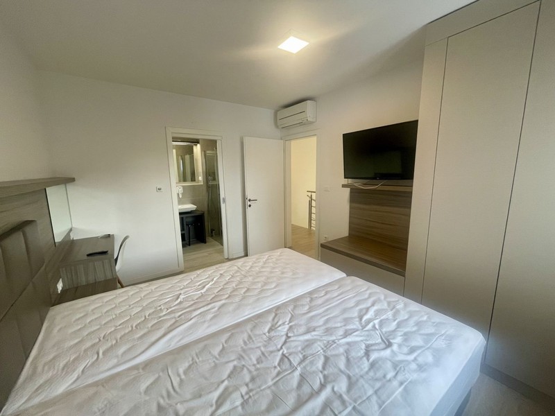 Bedroom with television and air conditioning unit