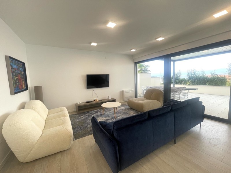Living room with armchairs and large window front