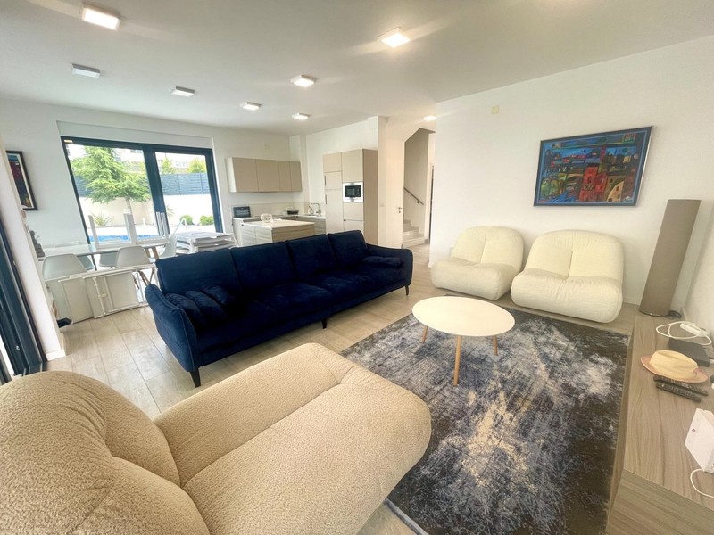 Open-plan living area with dining table by the window